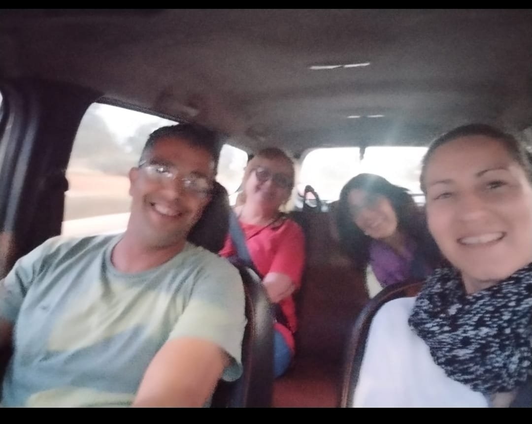 Group of smiling travellers during the ride
